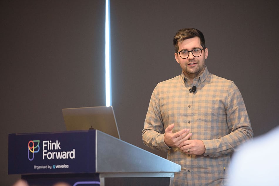 Presenter stands on the Flink Forward stage.