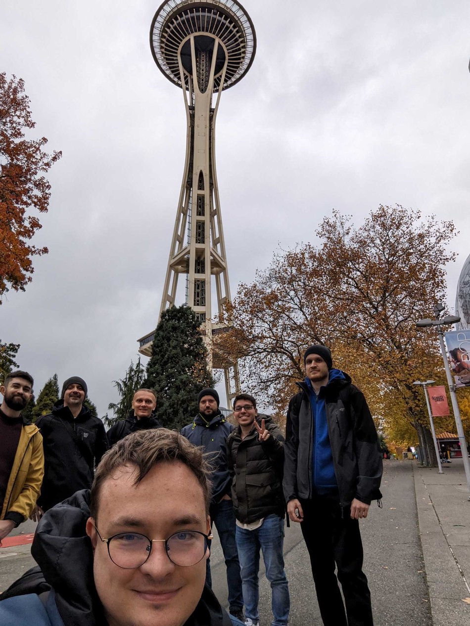 Members of the Ververica technical team stand below the Space Needle in Seattle, Washington.